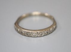 An 18ct white gold and nine stone diamond chip set half hoop eternity ring, size O, gross 2.6