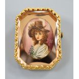 A yellow metal mounted octagonal brooch, with oval painted bust of a lady in mirrored surround,