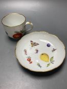 A Meissen cup and saucer, factory seconds, decorated with fruit and butterflies and lined with