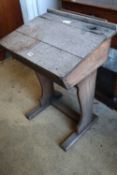 An early 20th century oak school desk, width 56cmCONDITION: Rather faded with a damp stain to the