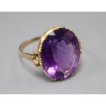 A 19th century gold and amethyst dress ring (tests as 9ct), with collet setting and carved