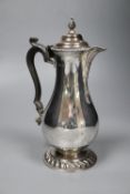 A George V silver baluster hot water pot, with ebonised handle, Goldsmiths & Silversmiths Co Ltd,