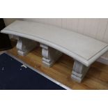 A reconstituted marble concave garden bench, width 150cm height 46cmCONDITION: Top looks to have