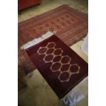 A Bokhara brick red ground rug, 217 x 147cm and a similar later rug, 110 x 74cmCONDITION: Bokhara