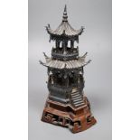 An early 20th century Chinese white metal miniature model of a pagoda, on a hardwood base, model