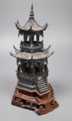 An early 20th century Chinese white metal miniature model of a pagoda, on a hardwood base, model