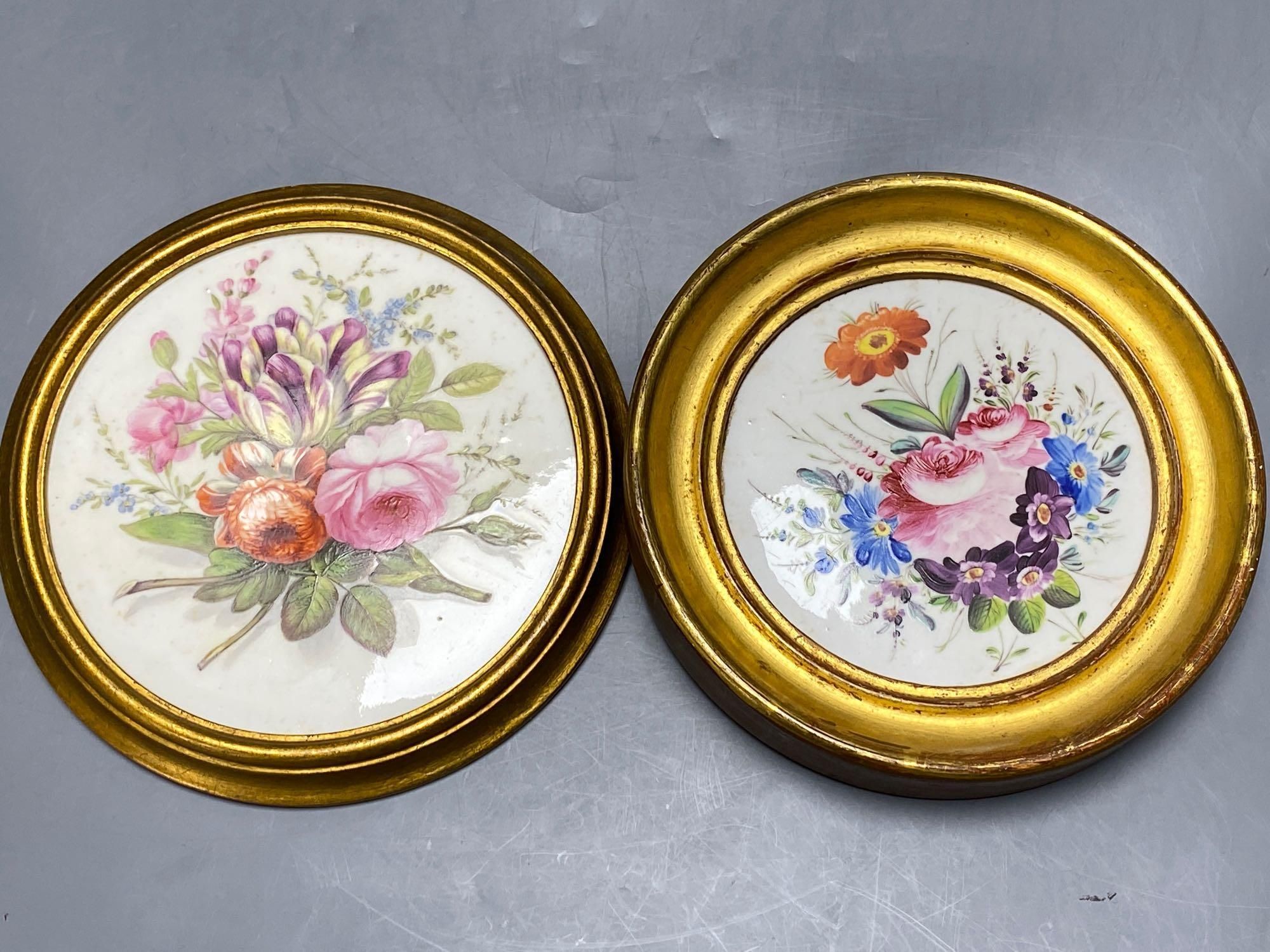 Two early 19th century circular wall plaques, each painted with floral bouquets, one Derby, 18cm and