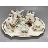 A late 19th century French porcelain flower encrusted cafe au lait set, on stand, stand