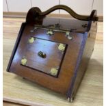 A Gothic revival walnut and brass mounted coal box on ceramic casters, 35cm wideCONDITION: The sides