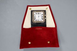 A Cartier stainless steel travelling alarm timepiece, with original fabric pouch