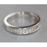 A modern 750 white metal and channel set twenty stone diamond half eternity ring, size O, gross 3.