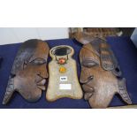 Two carved wooden face masks and a shagreen mirrorCONDITION: No structural damage.