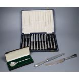 A cased set of 6 pairs of silver handled dessert knives & forks, a Peter Jackson Christmas spoon and