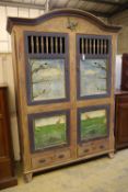 A 19th century Continental painted armoire, later decorated with birds on branches, rabbits and