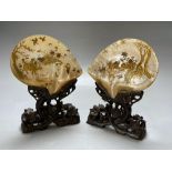 A pair of Chinese mother o'pearl dishes, gilt lacquered with figures and birds in landscapes, on