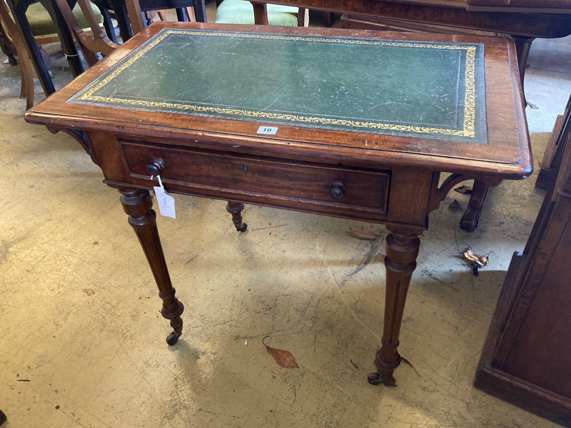 A late Victorian mahogany writing table, with leather lined top and ceramic castors, width