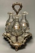 A set of three early 19th century glass decanters, now with facetted stoppers, and a silver label,