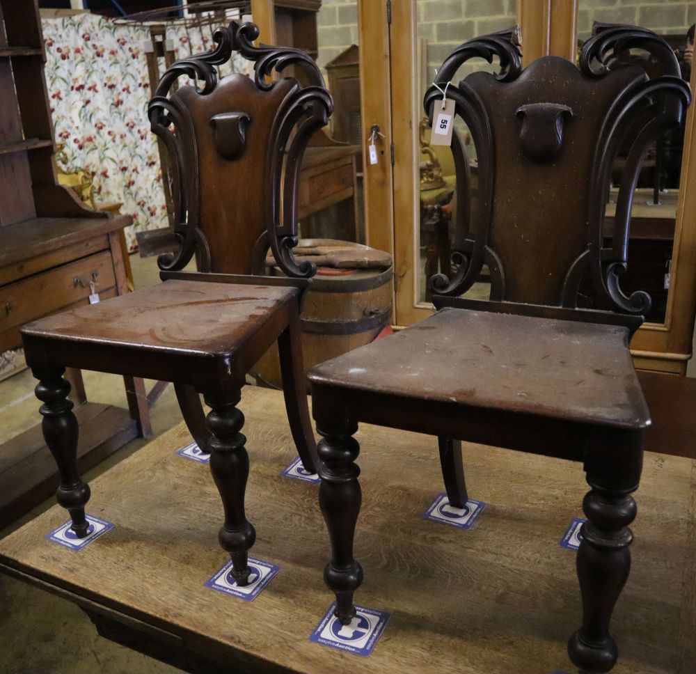 A pair of Victorian mahogany hall chairs (one a.f.)CONDITION: Fair wear and tear, one chairs has the