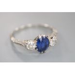 A mid 20th century white metal, sapphire and diamond three stone ring, size P, gross 3.6 grams.