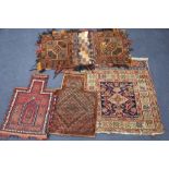 Two Afghan salt bags, a similar saddle bag and a Caucasian rug (4)CONDITION: Generally worn and