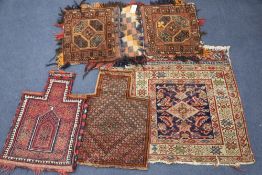 Two Afghan salt bags, a similar saddle bag and a Caucasian rug (4)CONDITION: Generally worn and