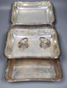 A pair of George V silver entree dishes and covers with handles and later engraved inscription,