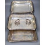 A pair of George V silver entree dishes and covers with handles and later engraved inscription,