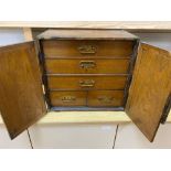 A Korean elm brass mounted table top cabinetCONDITION: Large splits to both doors, right hand door