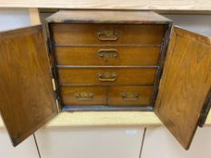 A Korean elm brass mounted table top cabinetCONDITION: Large splits to both doors, right hand door