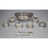 Six assorted silver napkin rings, a pair of tongs and a Dutch bon bon dish, gross 8oz.CONDITION: All