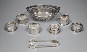 Six assorted silver napkin rings, a pair of tongs and a Dutch bon bon dish, gross 8oz.CONDITION: All