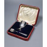 A cased Edwardian Art Nouveau silver egg cup and similar plated egg spoon, R & W Sorley, Glasgow,