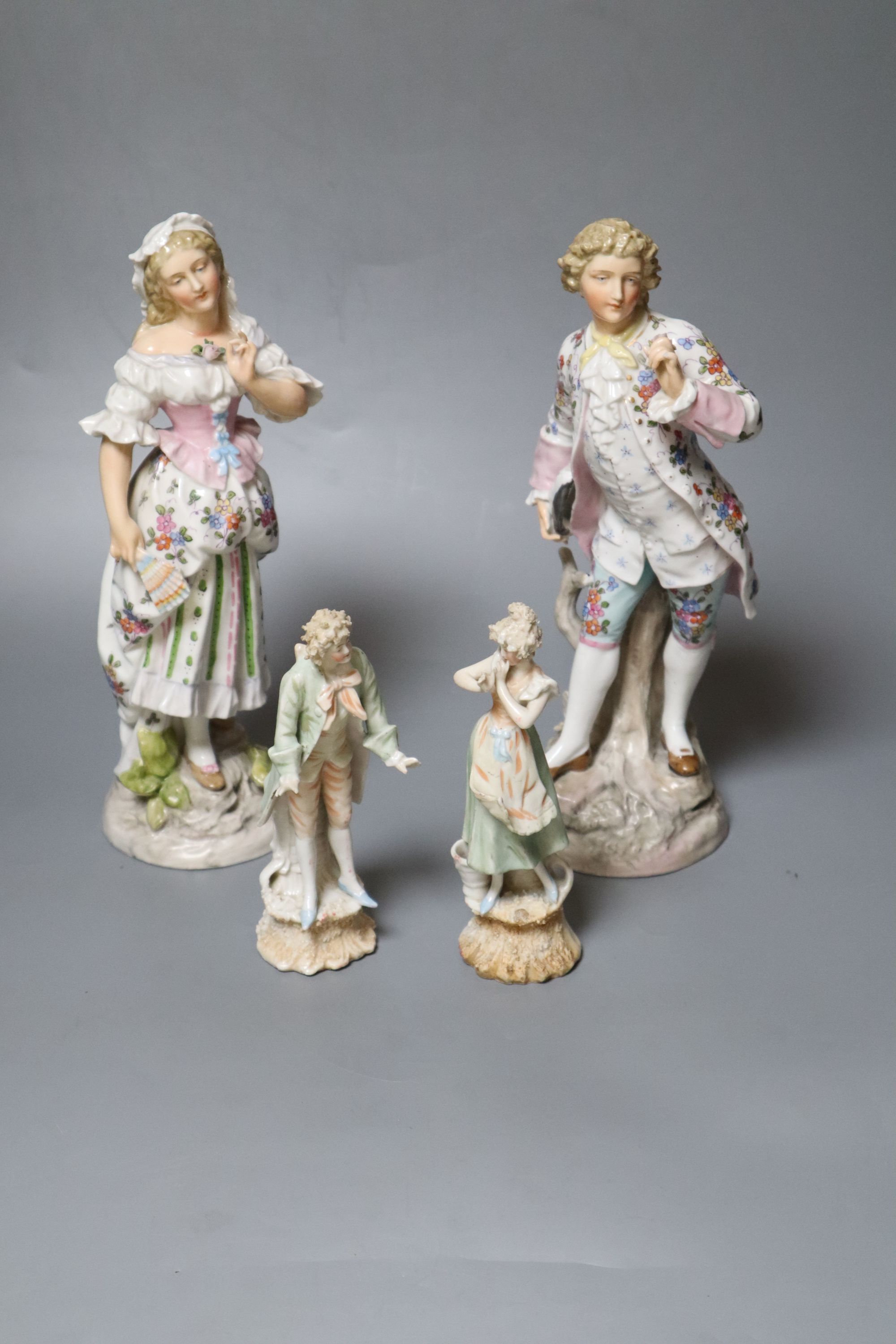 Two pairs of Continental porcelain figures of a man and woman, 15cm and 26cmCONDITION: Taller