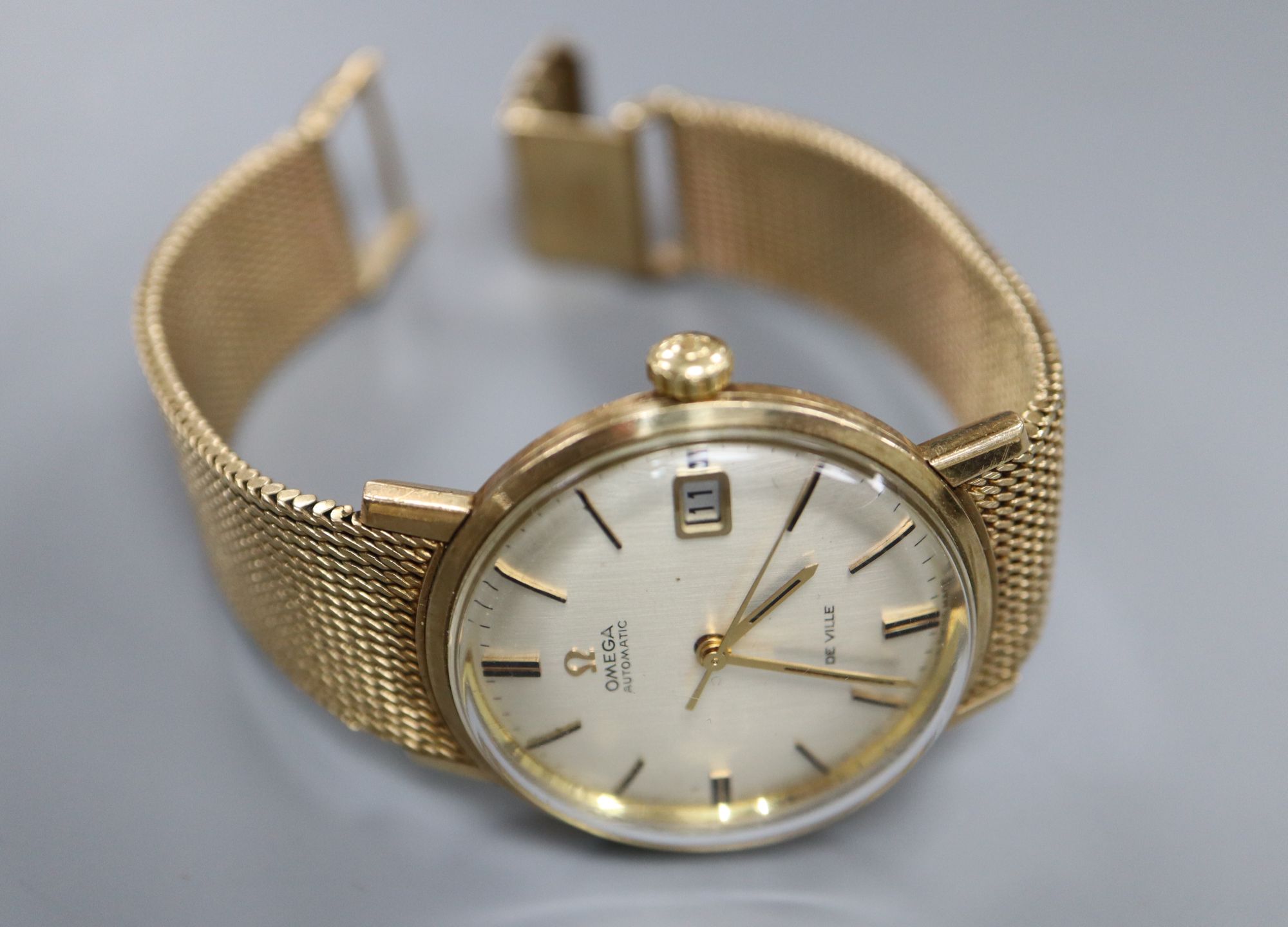 A gentleman's early 1970's 9ct gold Omega De Ville automatic wrist watch, on integral Omega 9ct gold