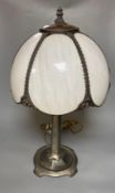 An Art Nouveau style metal table lamp with opaque white glass 'petal' shadeCONDITION: The column has