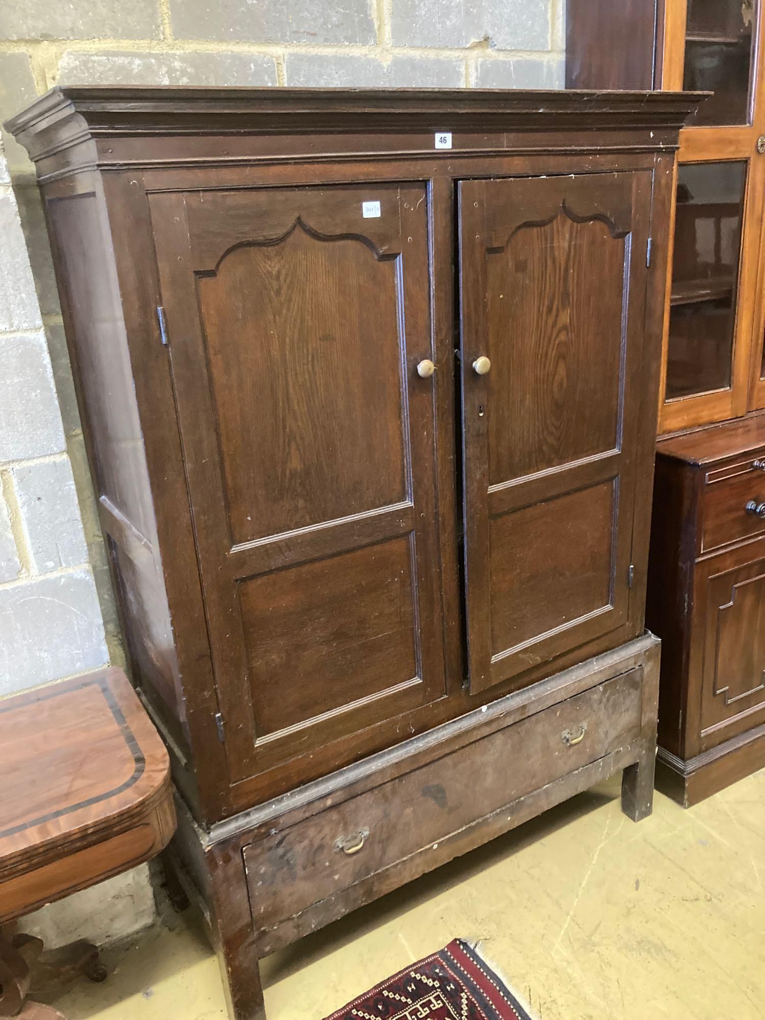 An 18th century oak press cupboard with base drawer, width 120cm height 169cmCONDITION: Overall