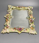 A porcelain floral encrusted wall mirror, German, Von Schierholz, 30 x 40cmCONDITION: Some chips