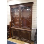 An Edwardian walnut bookcase, width 142cm height 225cmCONDITION: Of dark brown walnut tone but