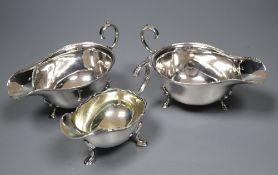 A pair of 1930's silver sauceboats, 5.5 oz and a plated sauceboat.CONDITION: One of the sauceboats