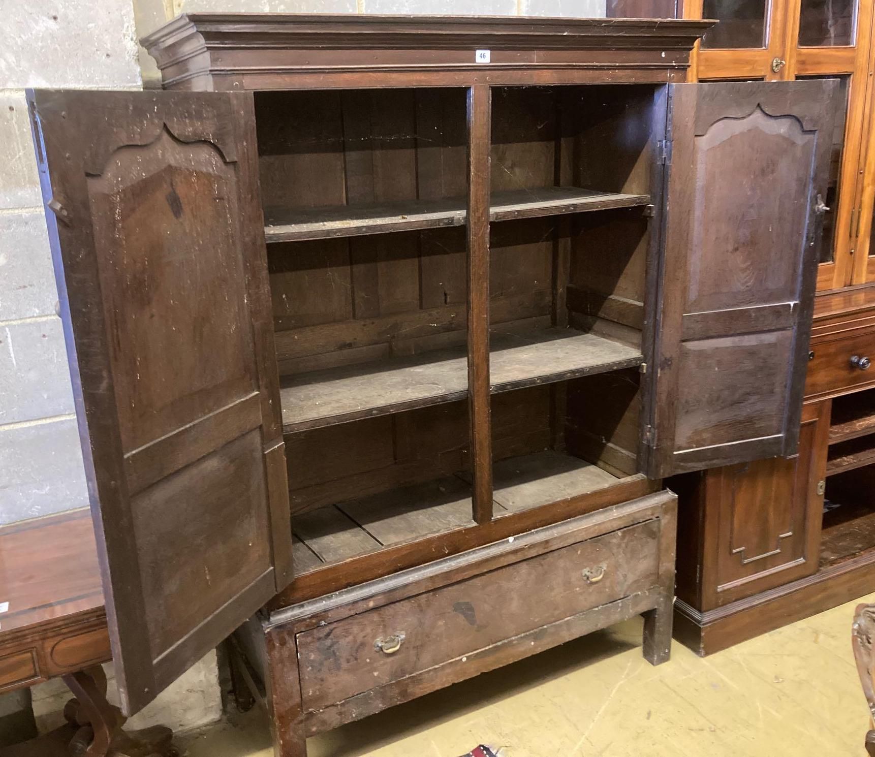 An 18th century oak press cupboard with base drawer, width 120cm height 169cmCONDITION: Overall - Image 2 of 3