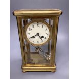 A four glass and brass mantel clock with mercury pendulum, 18cm high, 17cm wide,13cm