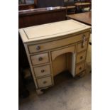 An early 20th century parcel gilt cream painted bowfront kneehole desk, width 78cmCONDITION:
