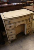 An early 20th century parcel gilt cream painted bowfront kneehole desk, width 78cmCONDITION: