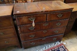 An early to mid 18th century chest with later top, two short and three long drawers, on later bun