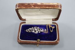 A Victorian yellow and white metal, round and rose cut diamond set scrolling bar brooch, 36mm, gross