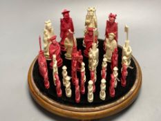 A 19th century Chinese ivory chess set, on a circular mahogany plinth, under glass dome, kings 10cm,