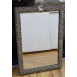 A large Edwardian repousse silver mounted easel frame toilet mirror, Henry Matthews, Birmingham,