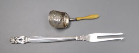 A 1950's Georg Jensen sterling pickle fork and a George III ivory handled silver caddy spoon.