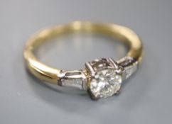 A modern 18ct gold and single stone diamond ring, with trapeze cut diamond set shoulders, size O,
