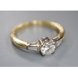 A modern 18ct gold and single stone diamond ring, with trapeze cut diamond set shoulders, size O,